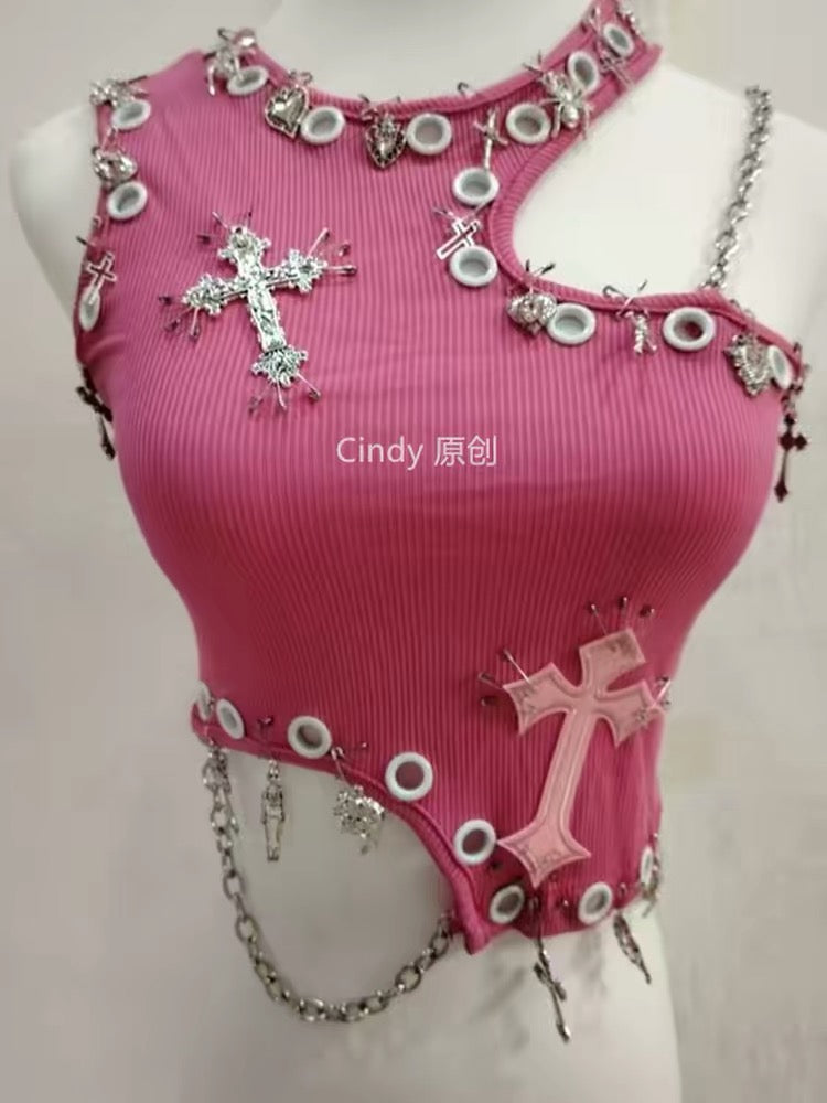 Close-up of pink crop top with cross appliques, metal eyelets and silver chain