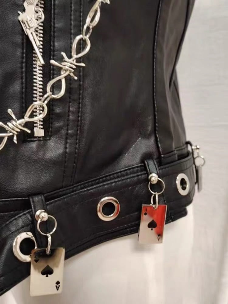 Close-up of black vest hem with eyelets and playing card charms
