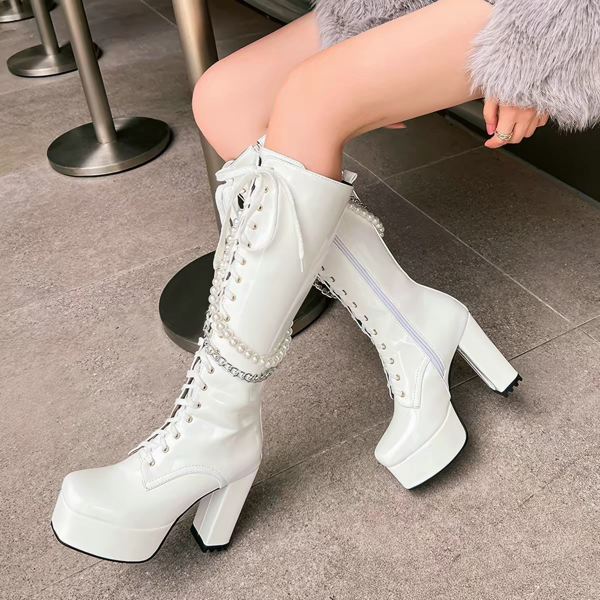 White knee-high platform boots worn