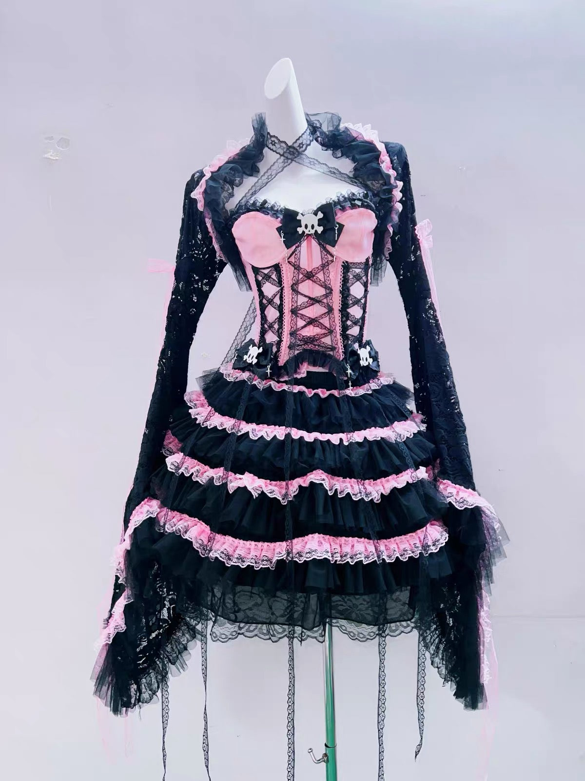 Pink and black lace bolero styled with coordinating corset and skirt