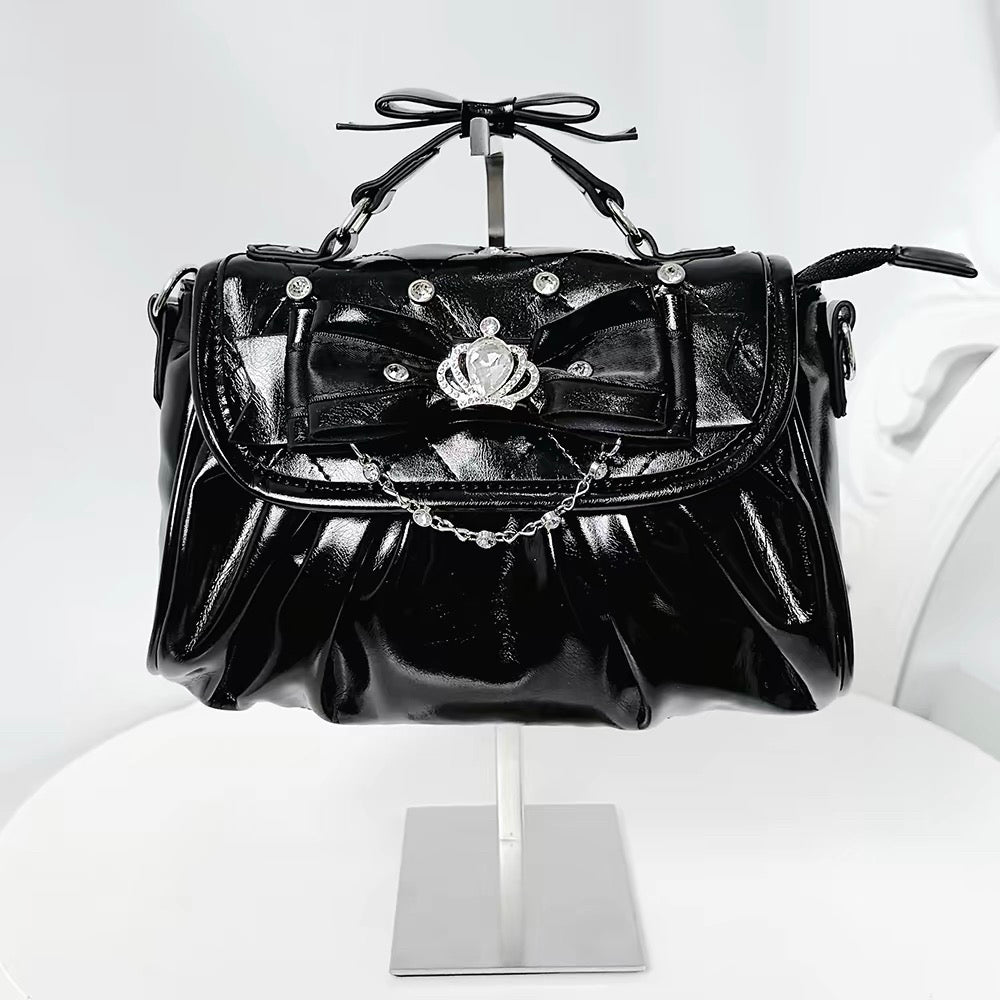 Black bow rhinestone handbag with pleated body and crown detail