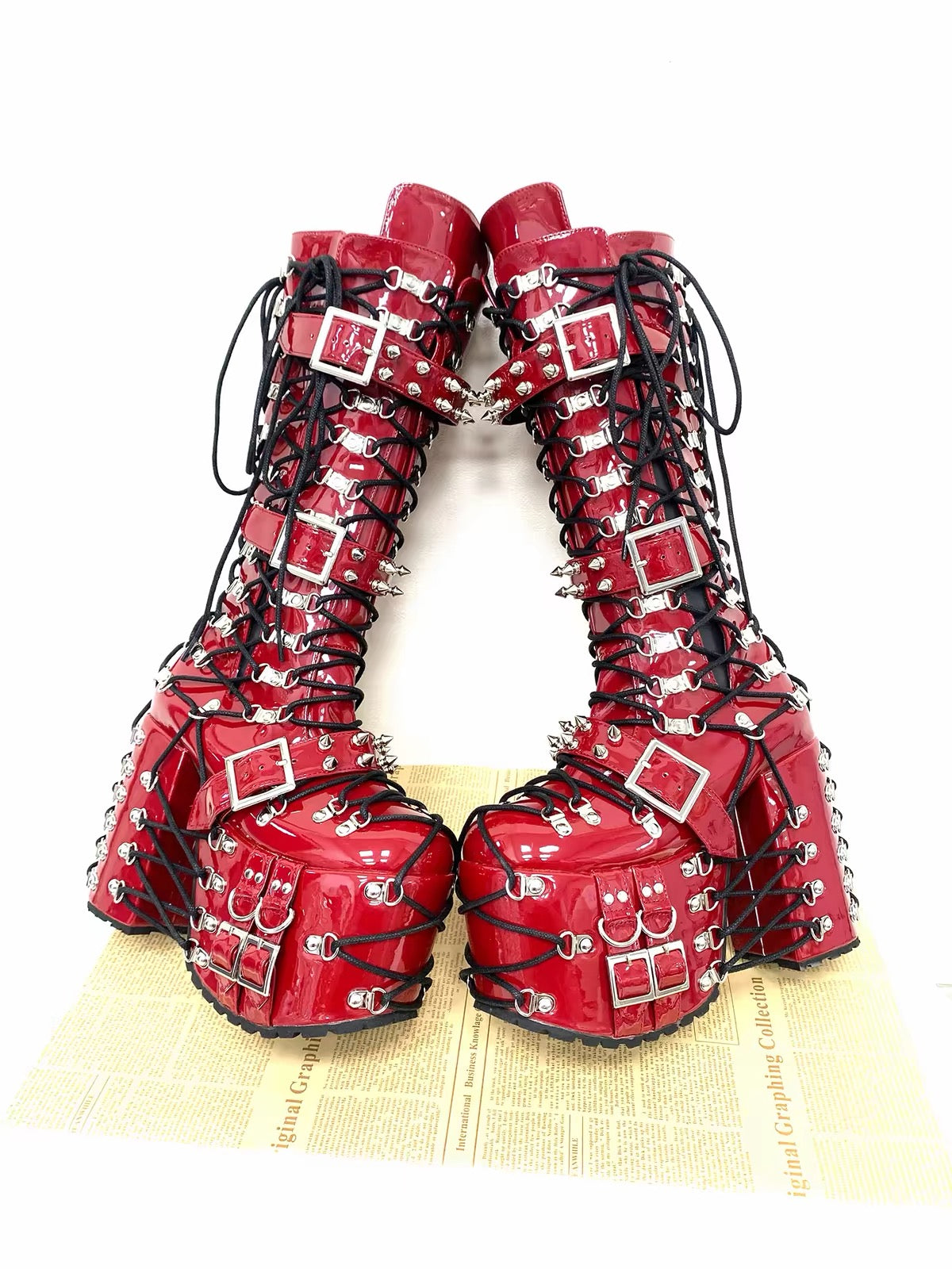Red statement platform boots with black laces and metal hardware