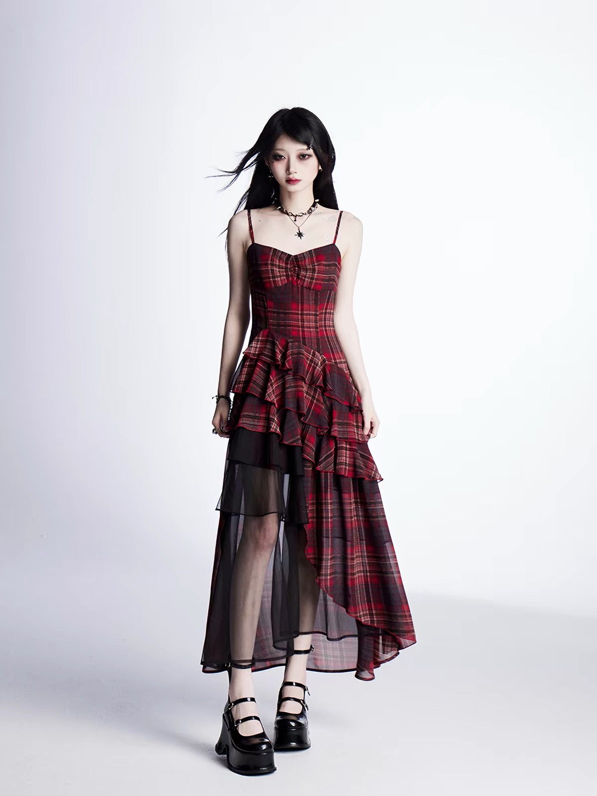 Model wearing red plaid asymmetrical dress without outer layer