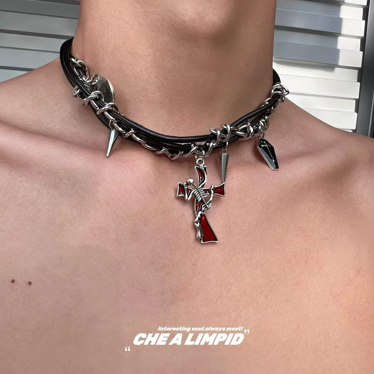 Black chain choker with red cross charm worn on neck