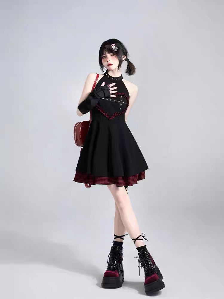 Black halter mini dress styled with red plaid accents