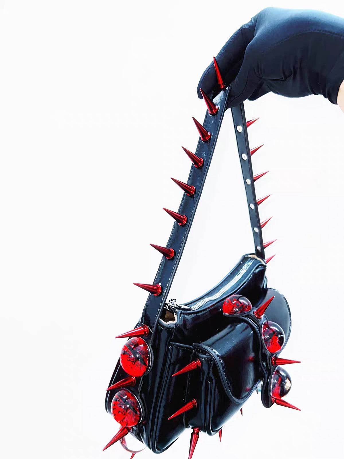 Black patent shoulder bag with red spikes alternate angle