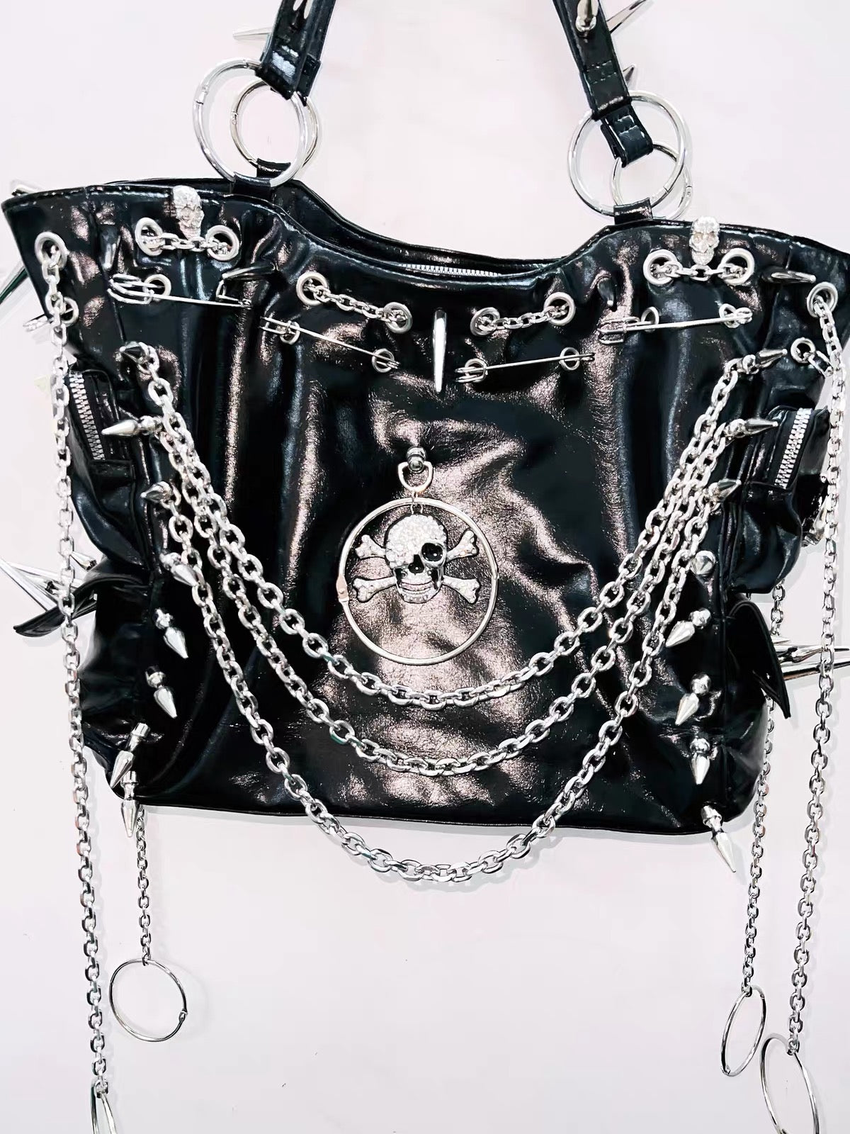Black spiked chain skull handbag hardware detail