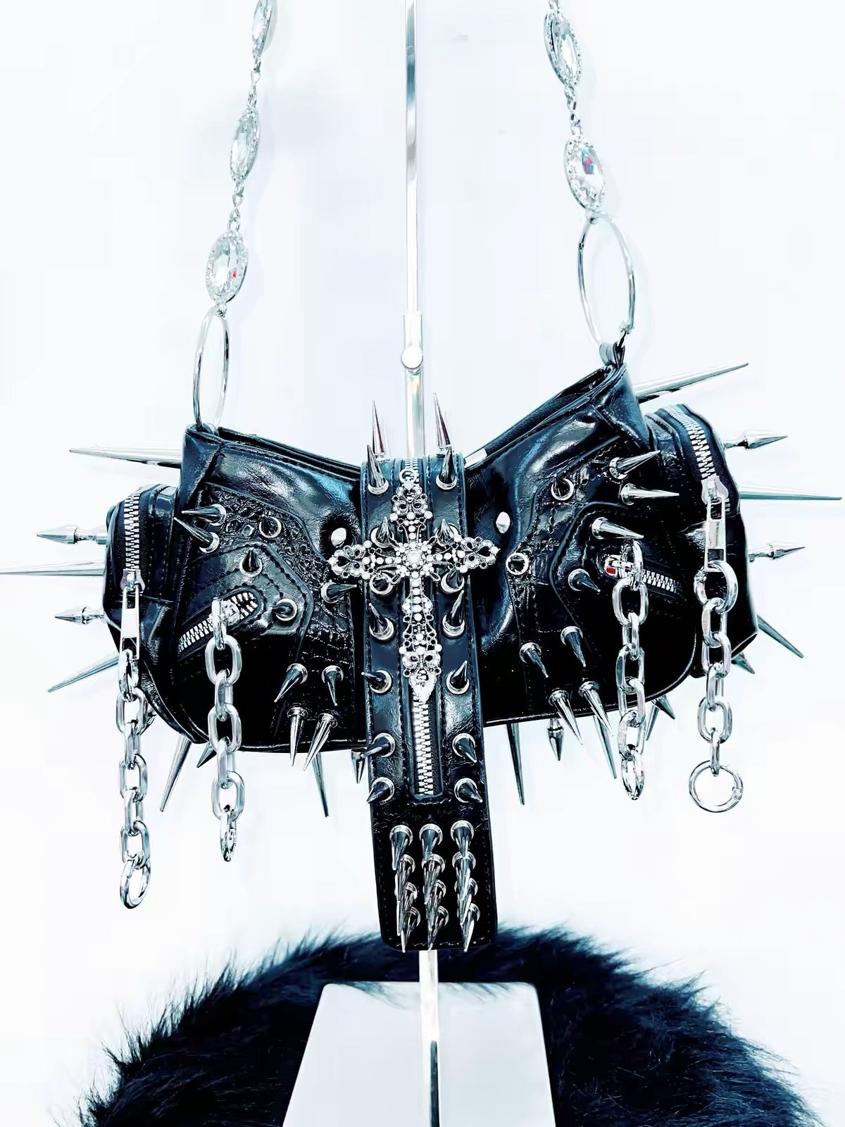 Black spiked cross handbag close-up
