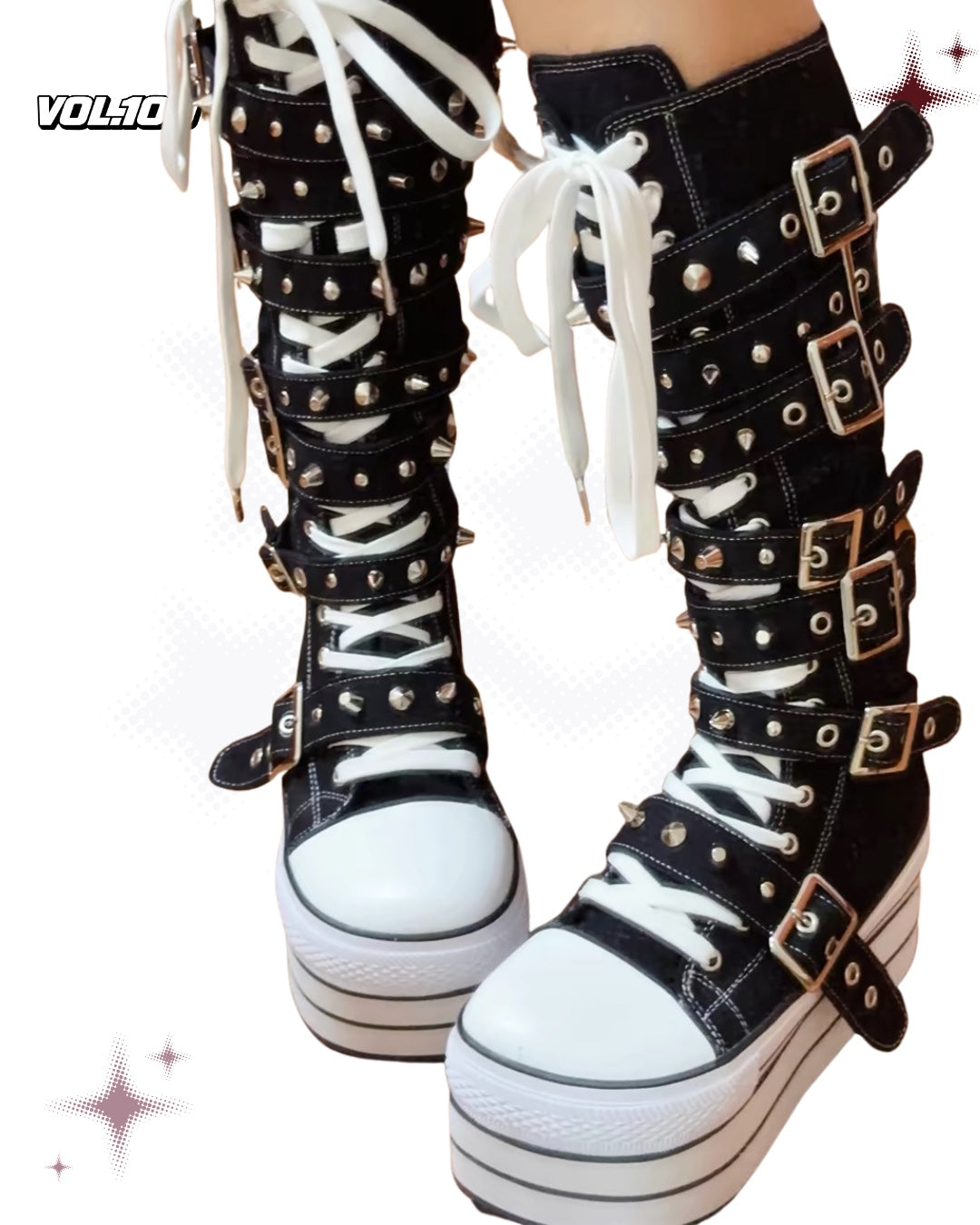 Front view of black and white knee-high platform boots with silver buckles and spikes