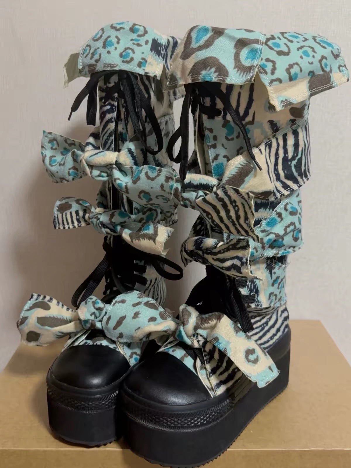 Blue animal print bow platform boots alternate front view