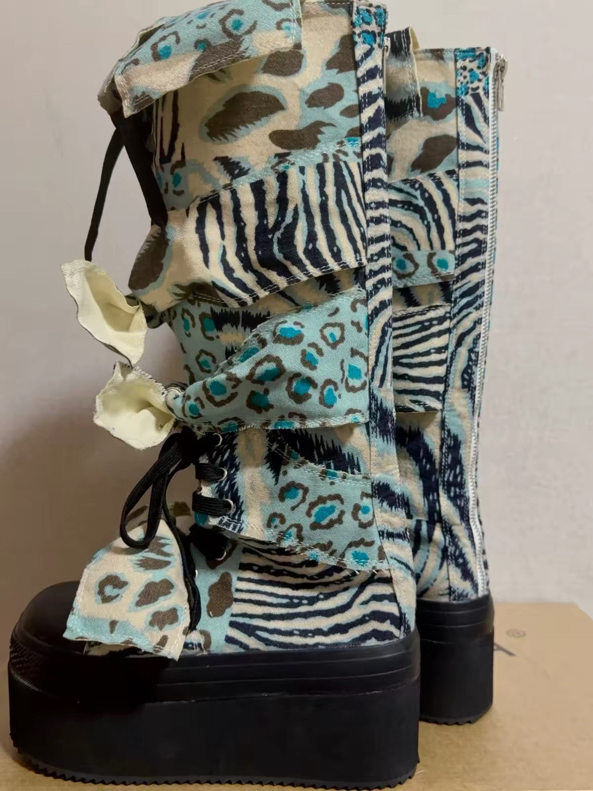 Blue animal print bow platform boots side view