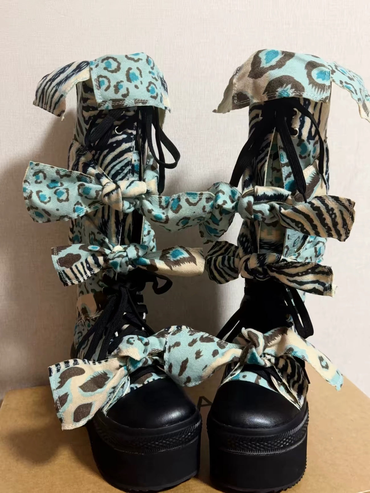 Blue animal print bow platform boots detail view
