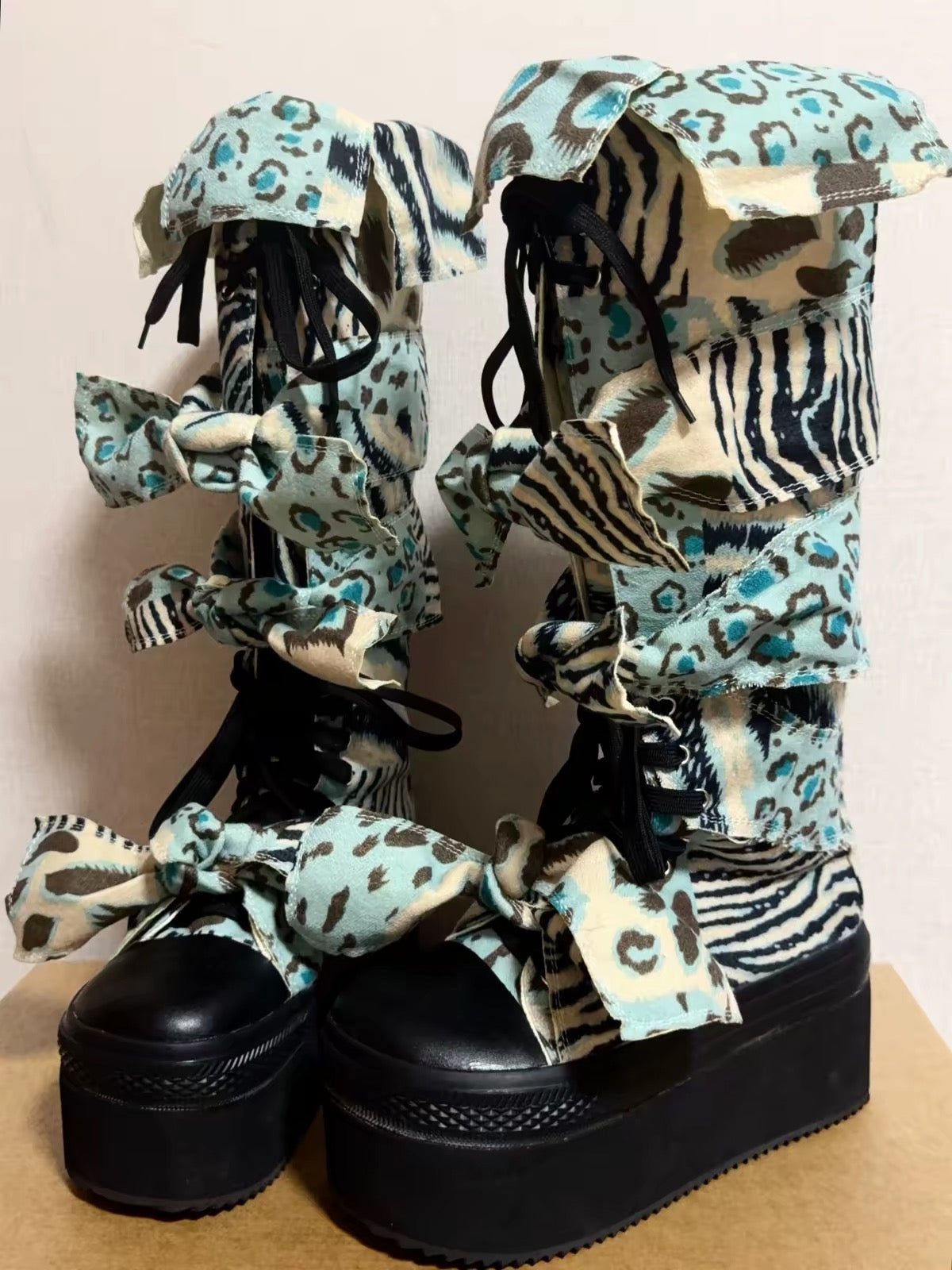 Blue animal print bow platform boots pair view