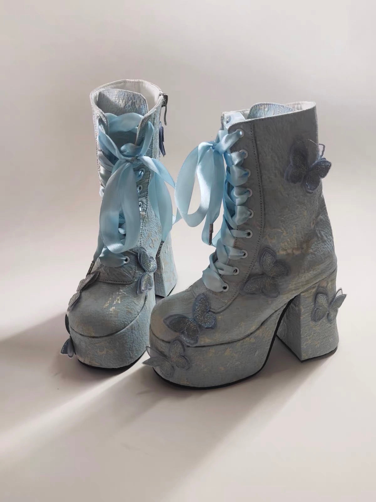 Blue butterfly platform boots front view