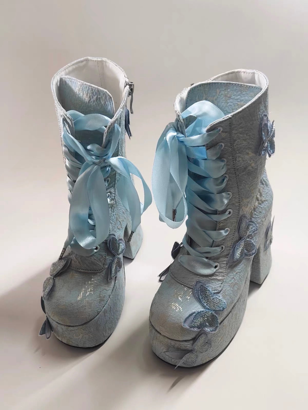 Blue butterfly platform boots pair