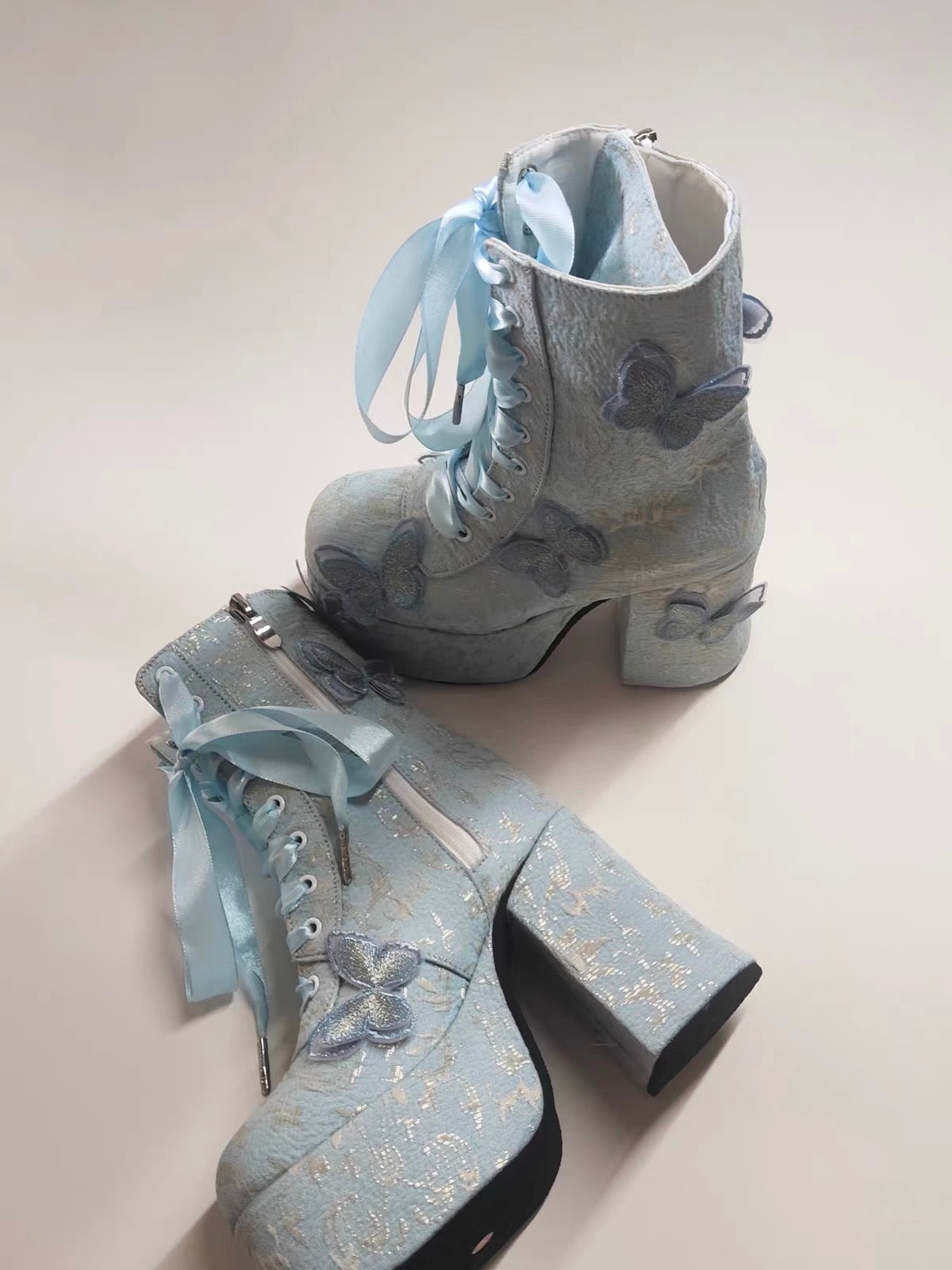 Blue butterfly platform boots side view
