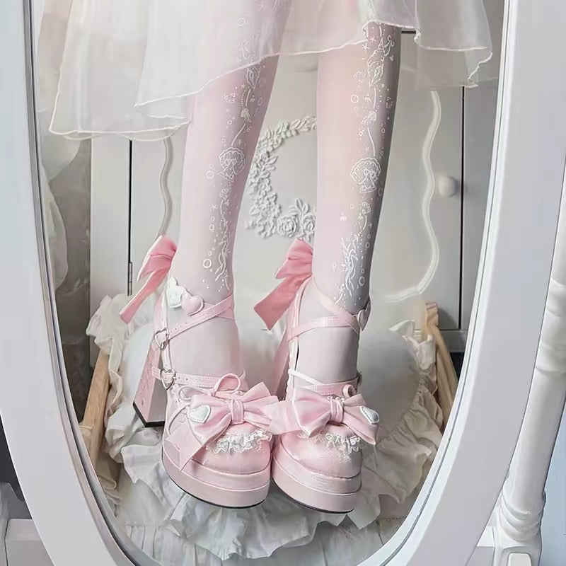Pink bow platform heels worn view