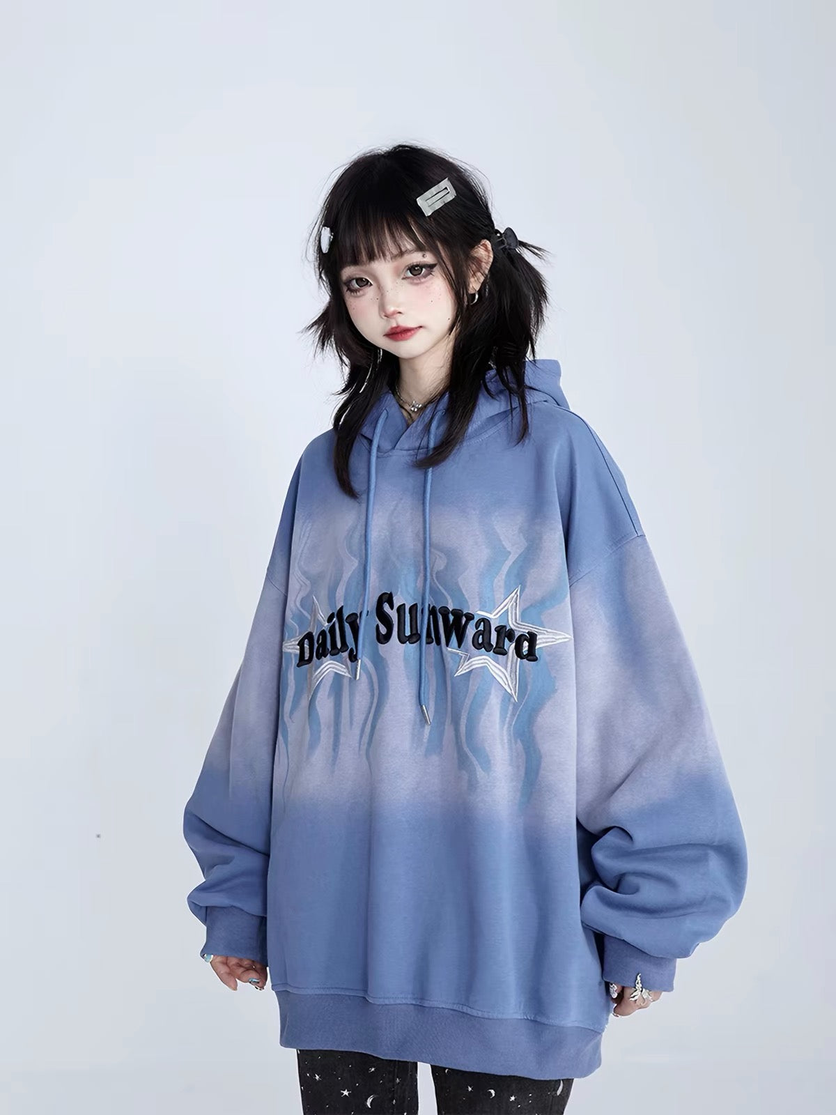 Model wearing oversized blue graphic hoodie