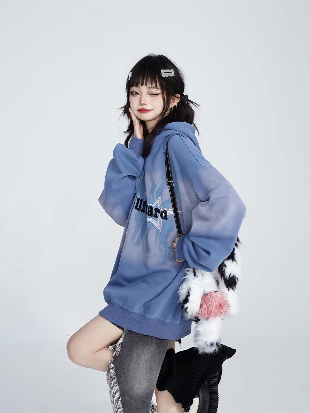 Side styling of blue oversized hoodie