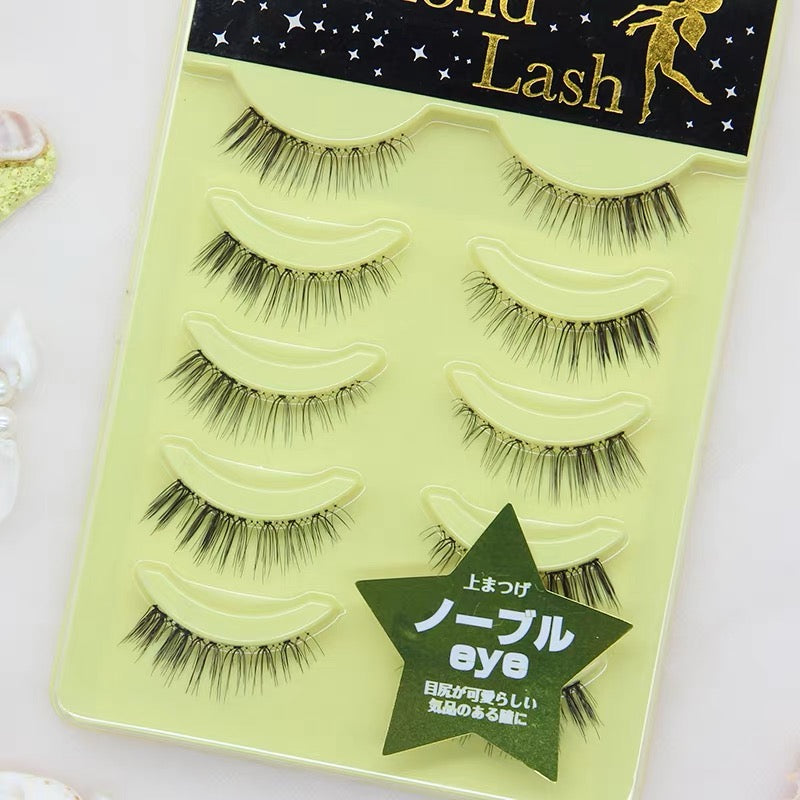 Close-up view of yellow Diamond Lash style dupe false eyelashes