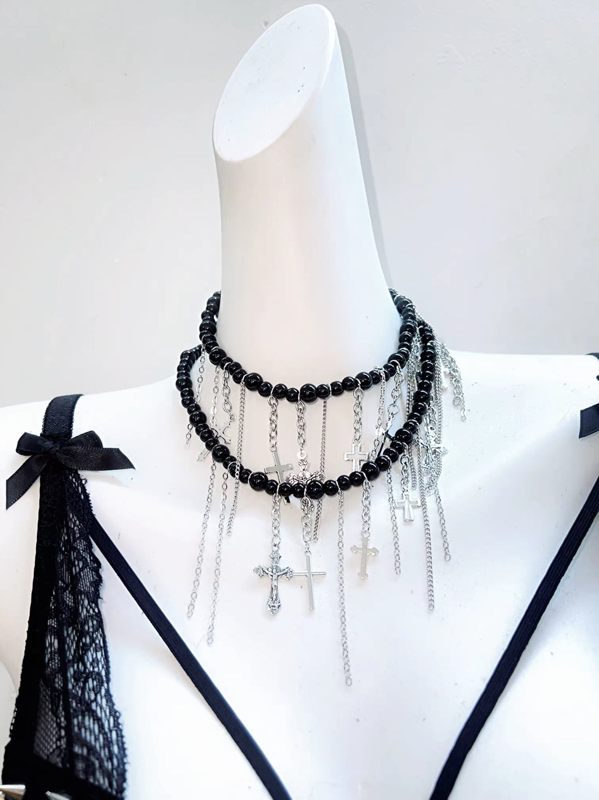Black bead and silver chain necklace with hanging cross charms