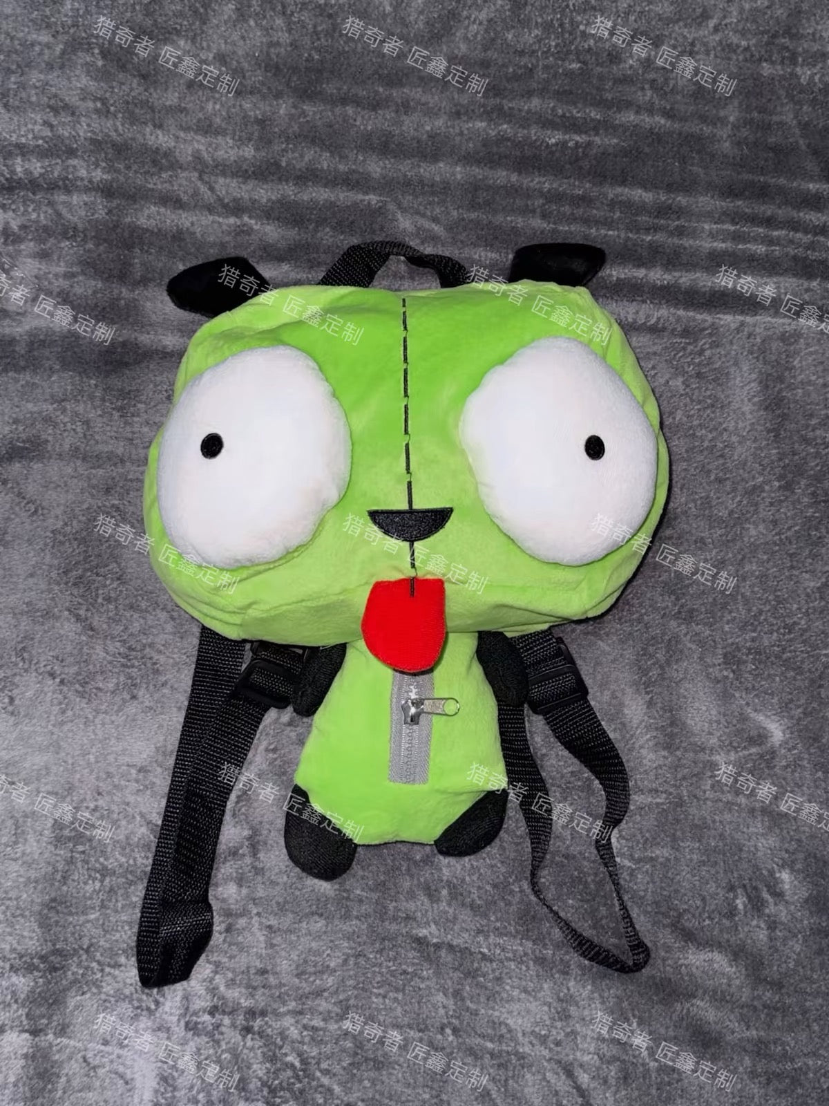 Green plush character backpack front view
