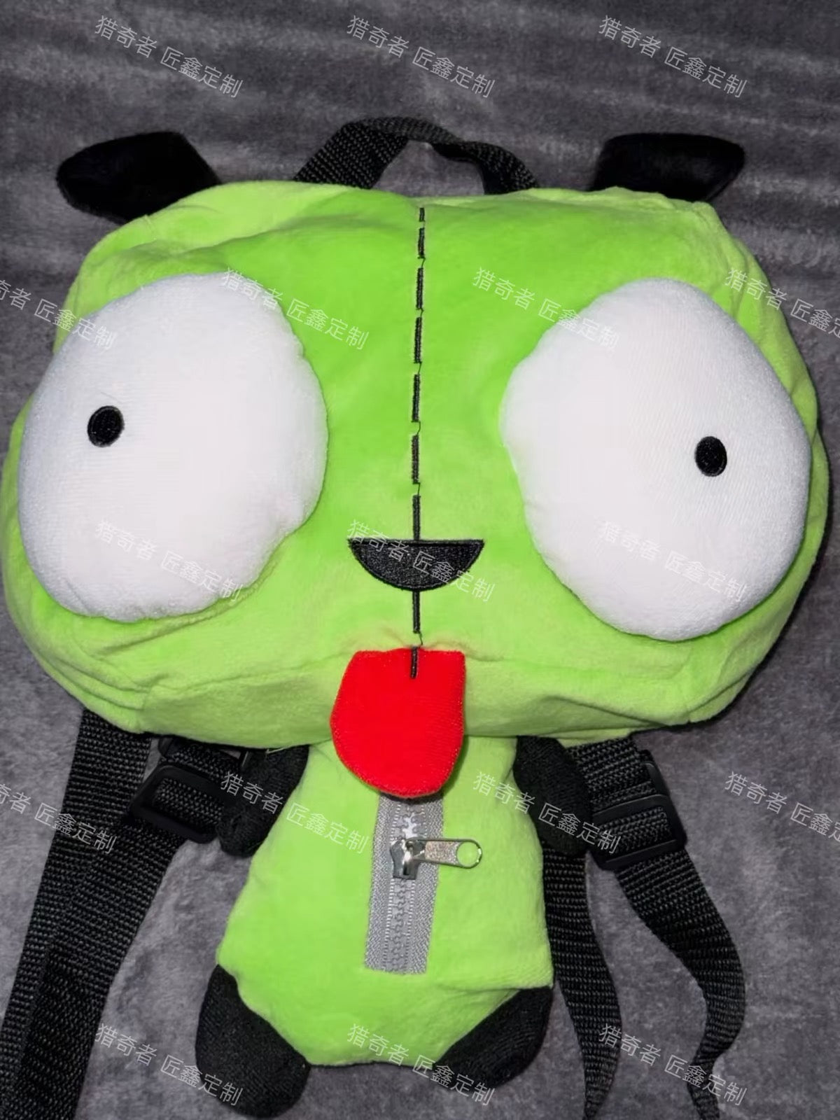 Green plush character backpack close-up