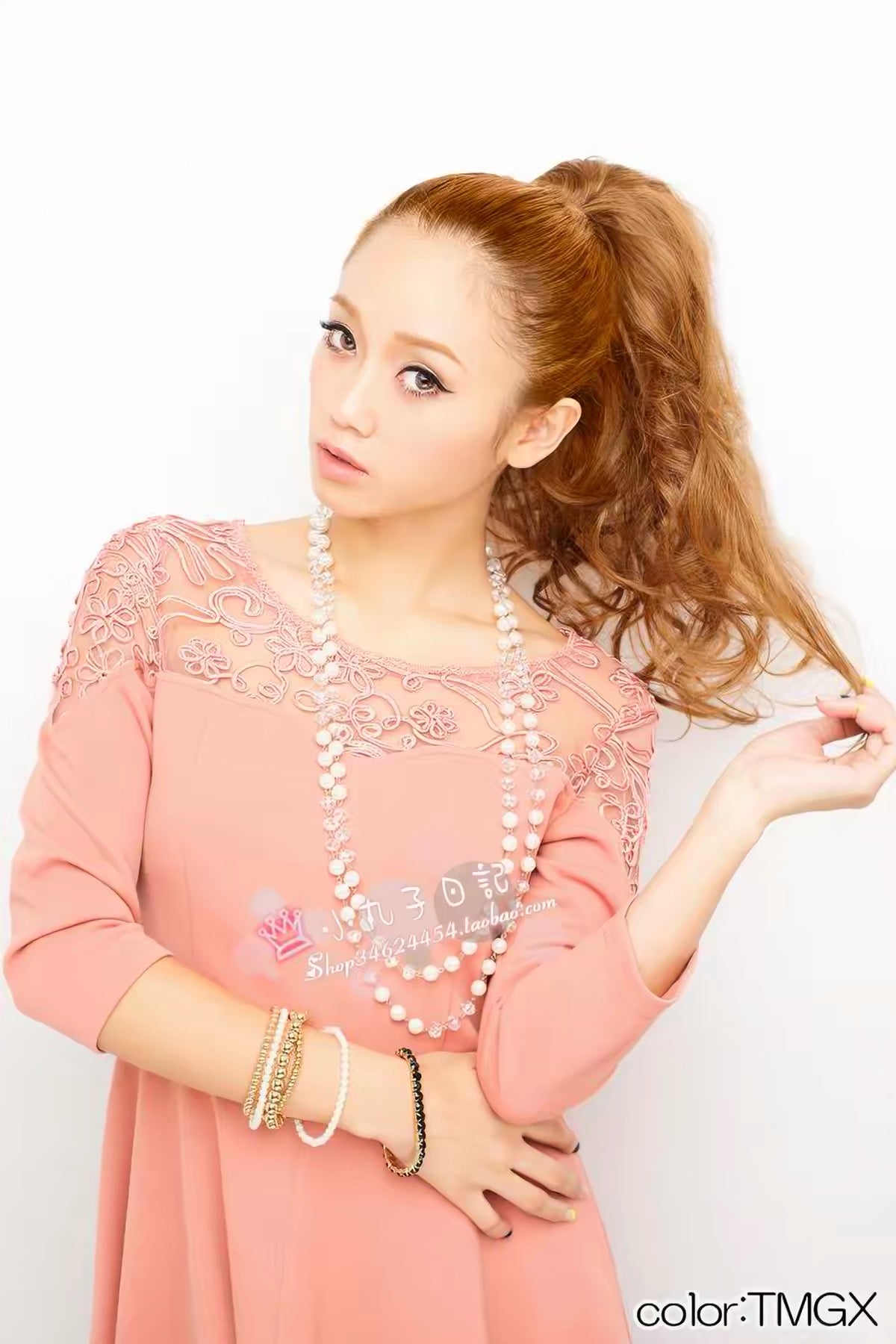 Front view of model wearing curly ponytail hair piece in warm brown shade