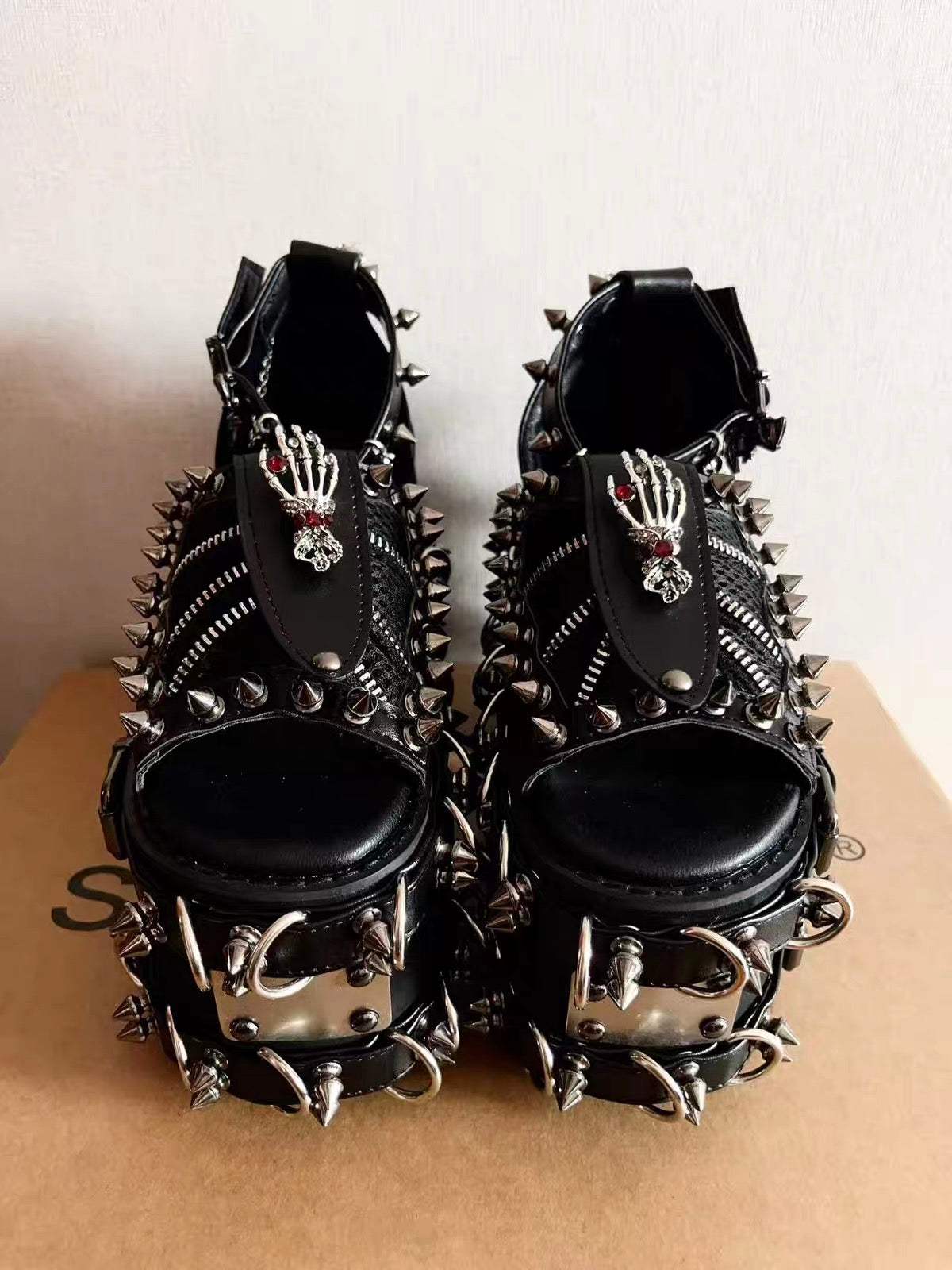 Black heavy spiked platform sandals angled front view