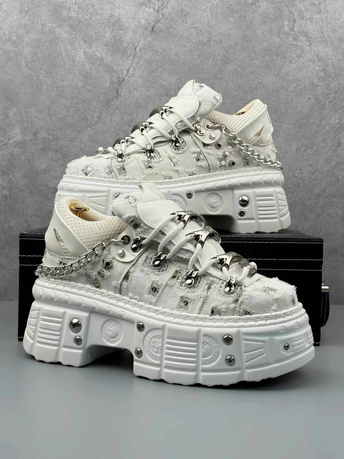 White industrial platform sneaker with chain and metal hardware