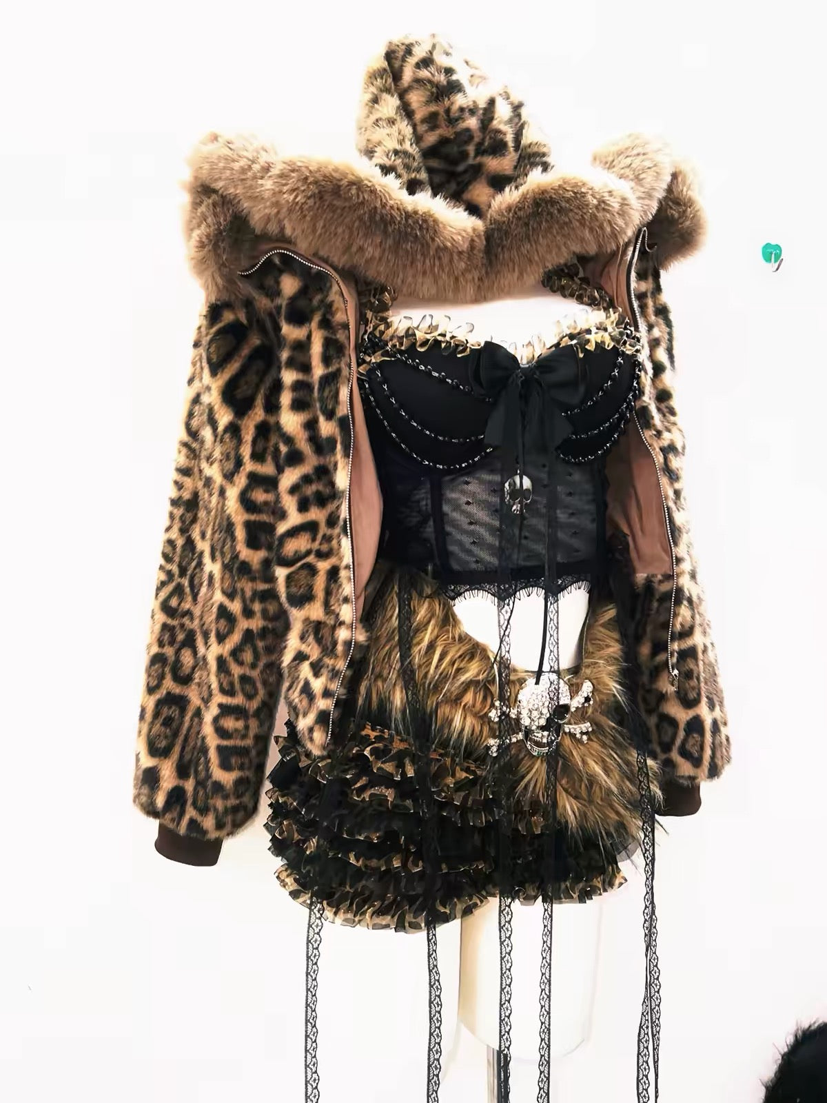 Leopard print hooded jacket open over lace top and ruffled shorts