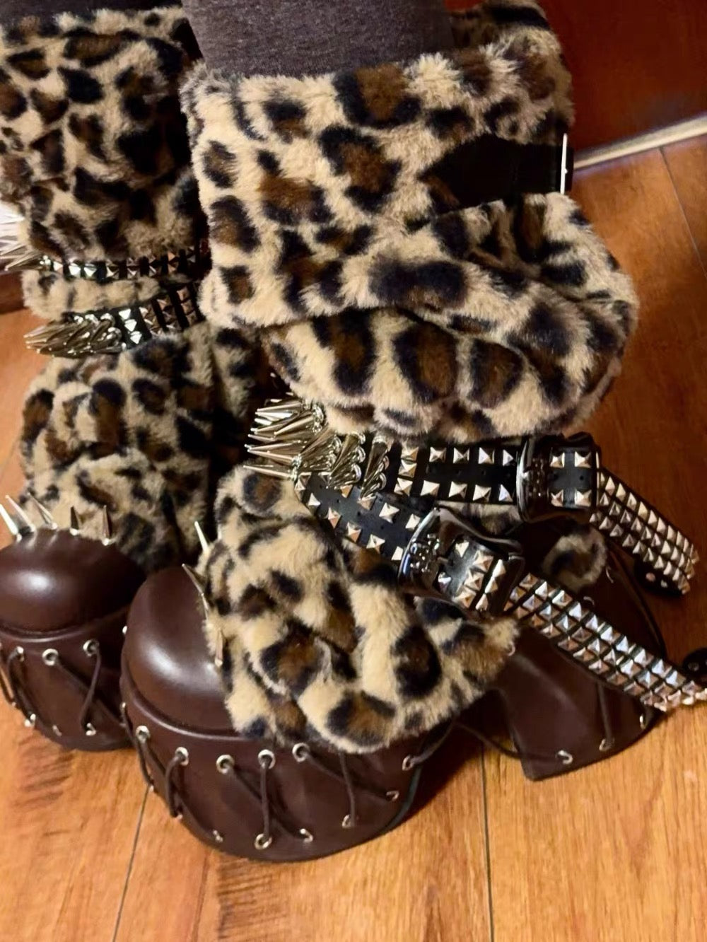 Leopard platform boots close-up with studded straps, spikes and faux fur