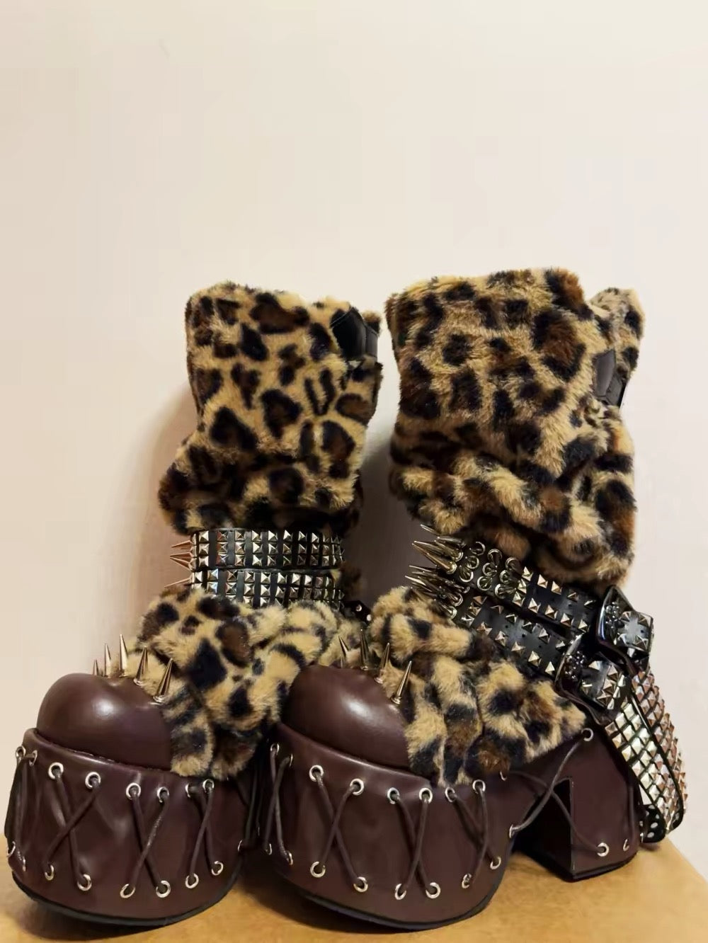 Leopard faux fur platform boots pair with brown platforms and spikes