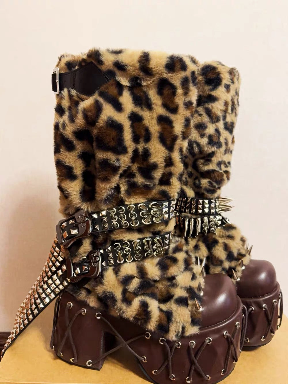 Side view leopard faux fur platform boots with brown platform and studded belts