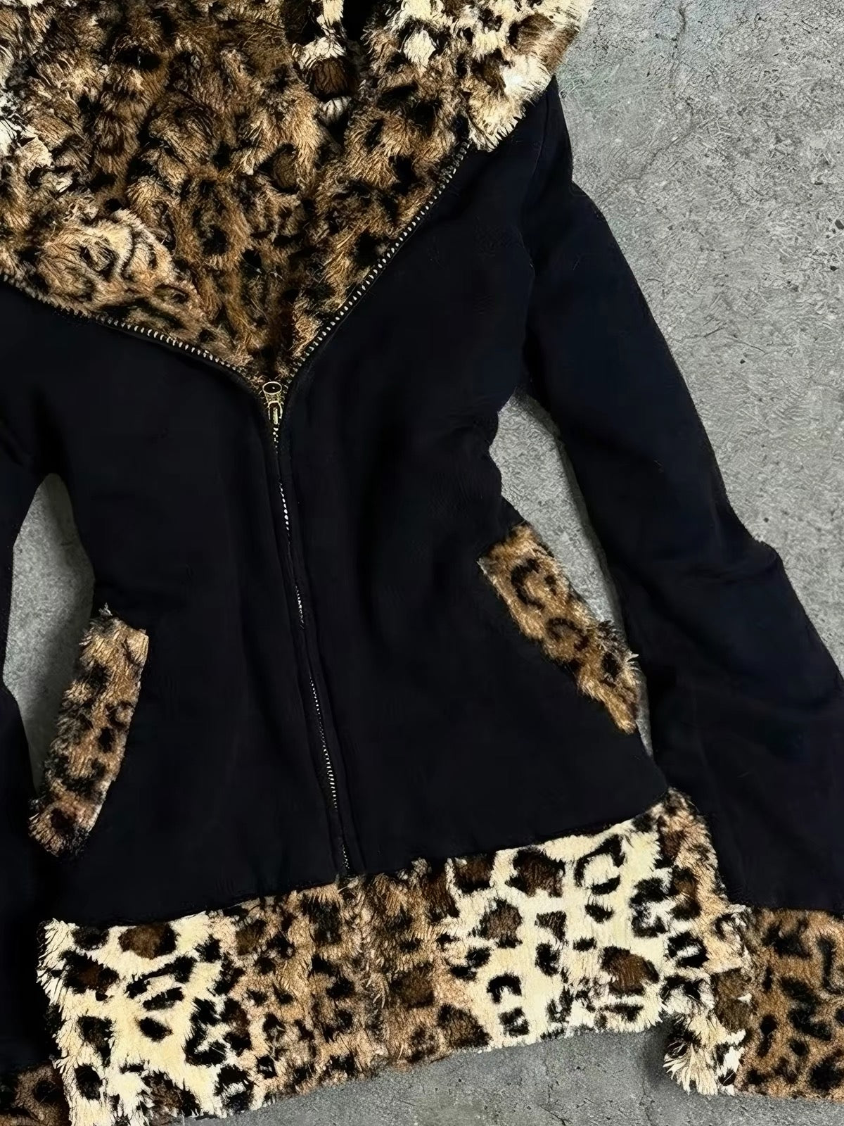 Close-up of black jacket with leopard faux-fur trim