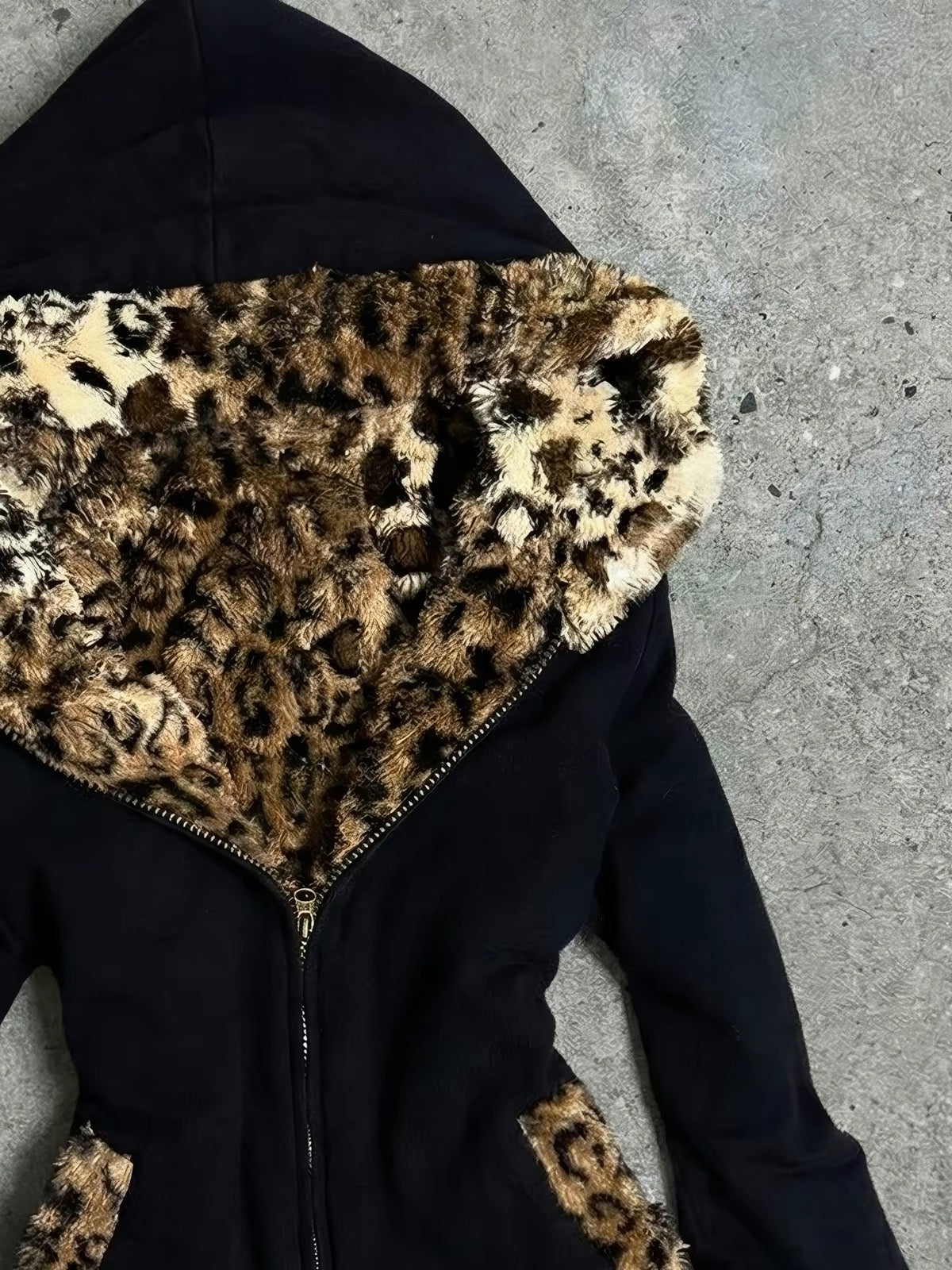 Leopard faux-fur hood detail on black fitted jacket