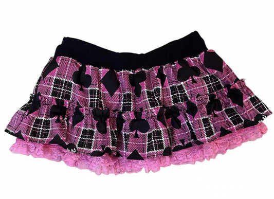Pink and black plaid tiered ruffle mini skirt with card suit motifs and pink lace trim