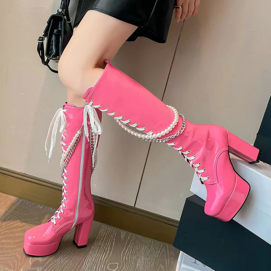 Hot pink knee-high platform boots with pearl and chain details