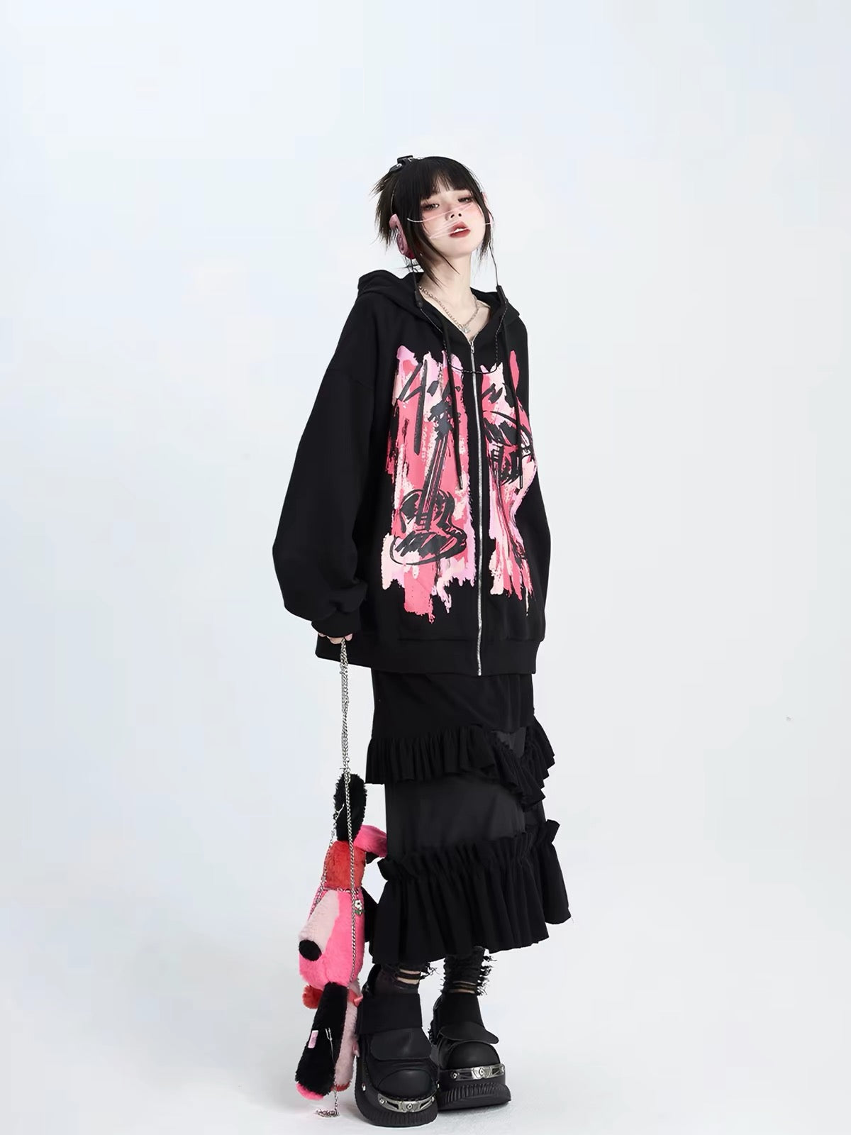 Black oversized hoodie with pink print styled with long skirt