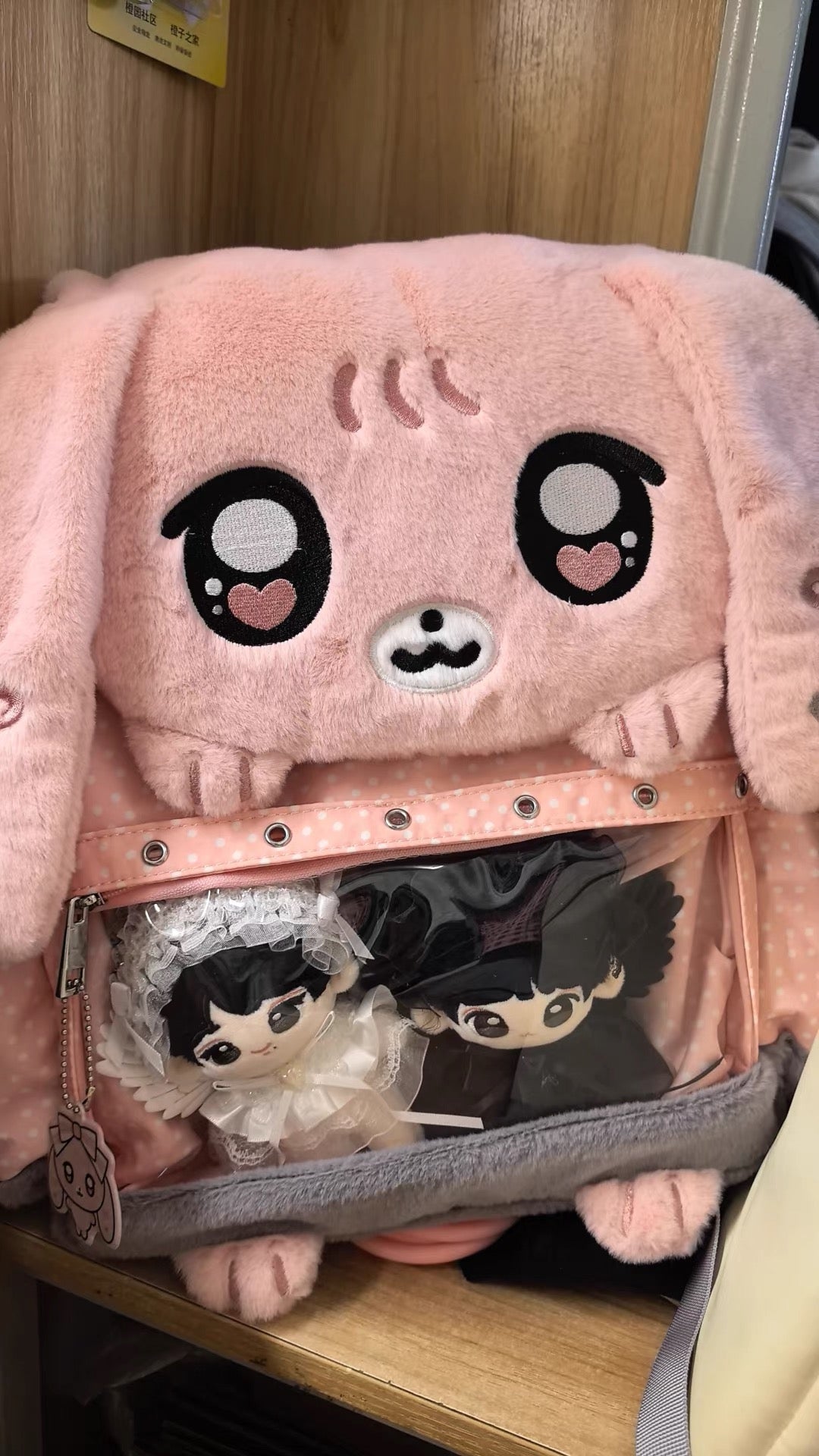Close-up of pink bunny display backpack customized with plushies