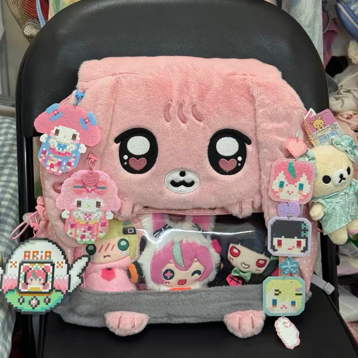 Pink bunny display backpack decorated with charms and plushies