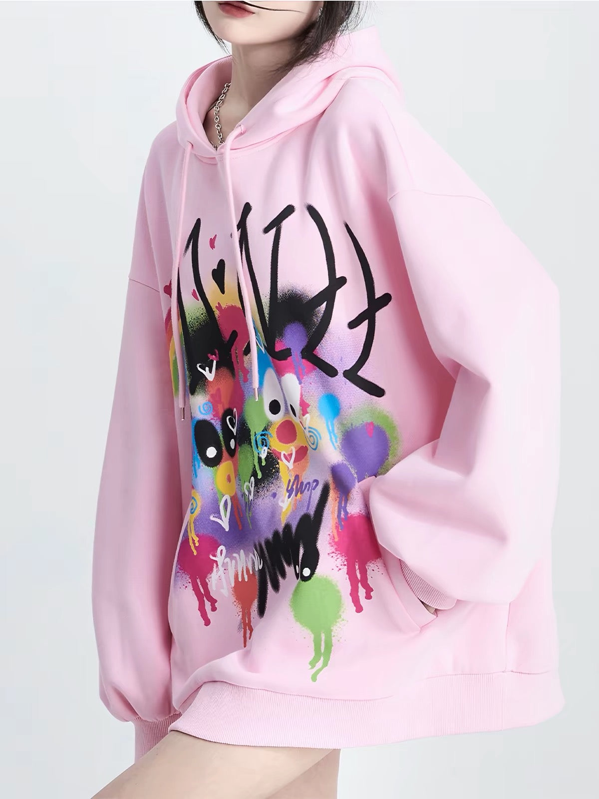 Close view of pink hoodie with colorful graphic