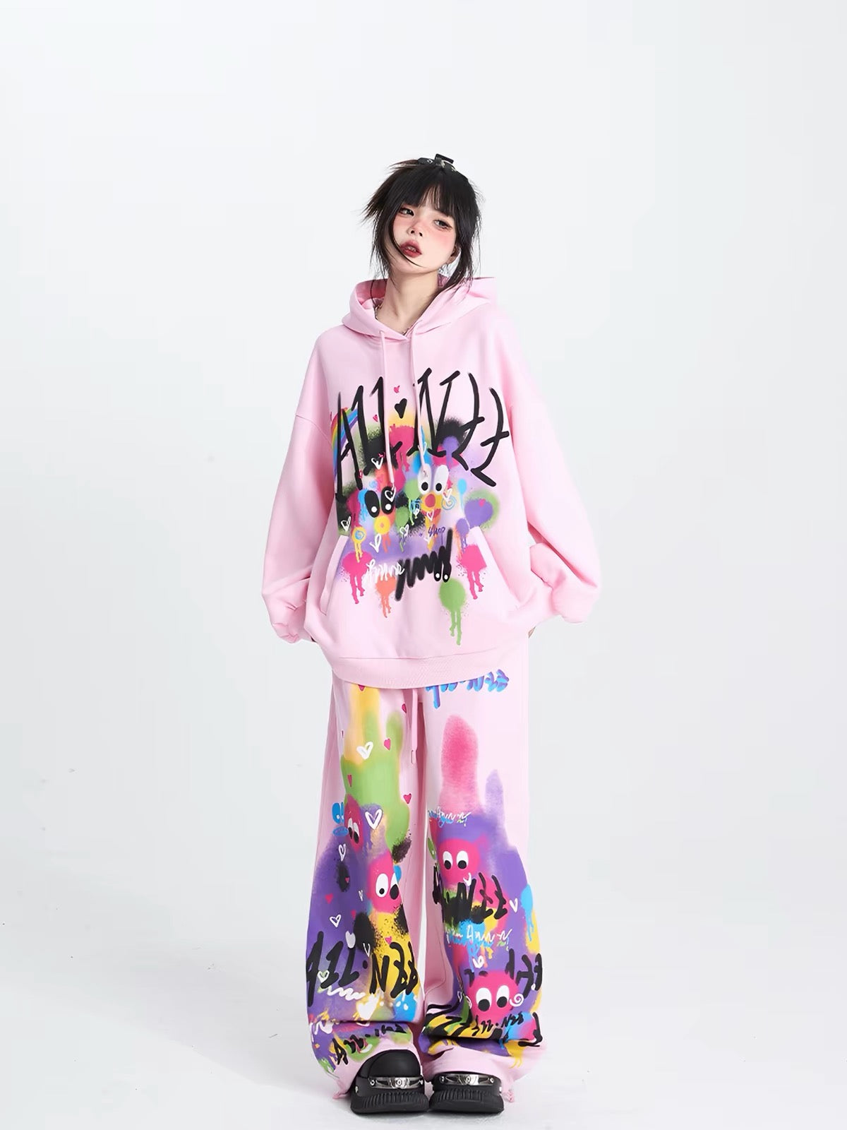 Pink graphic hoodie styled with matching printed pants
