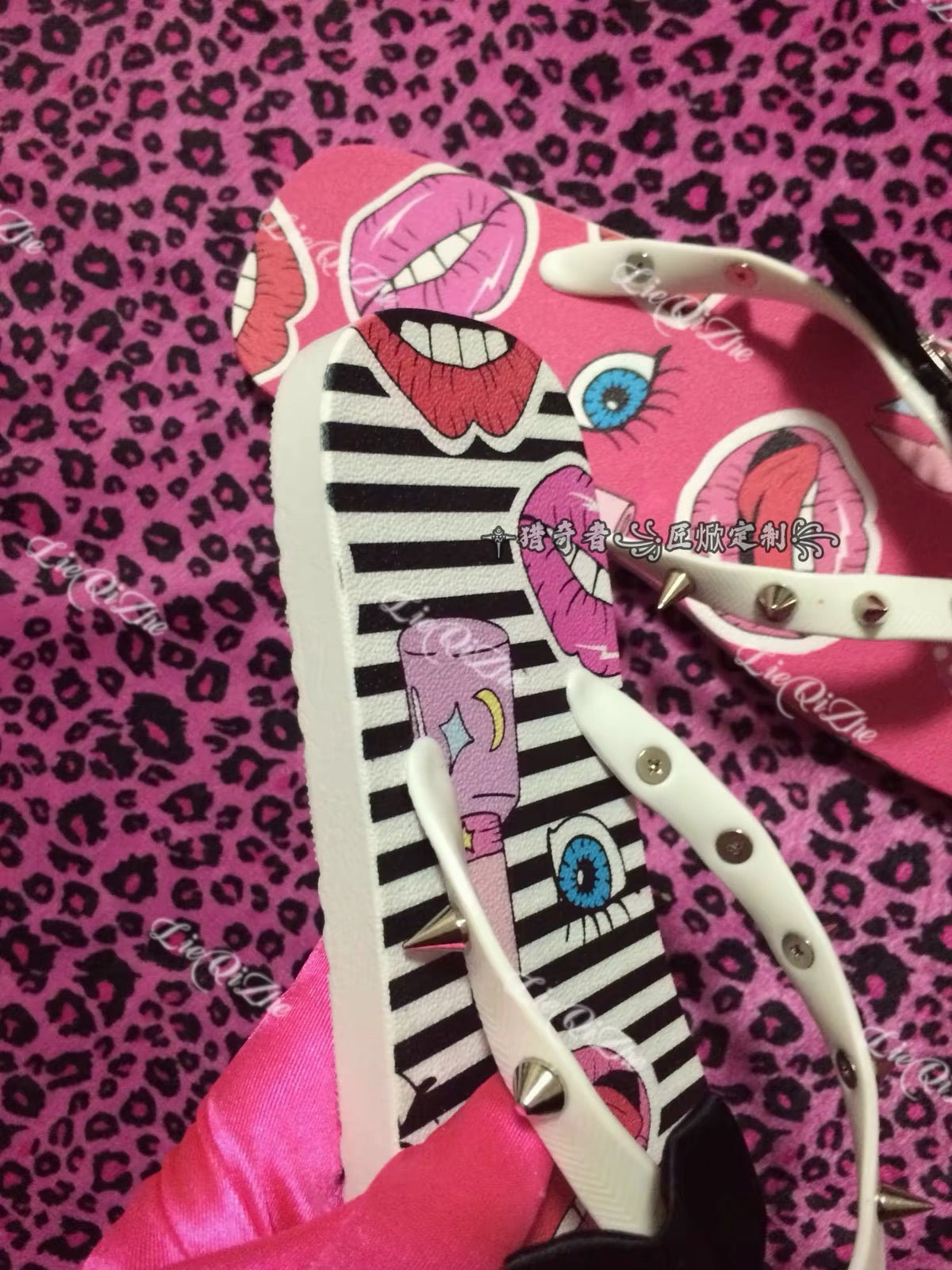 Close-up of graphic flip-flops with spike details