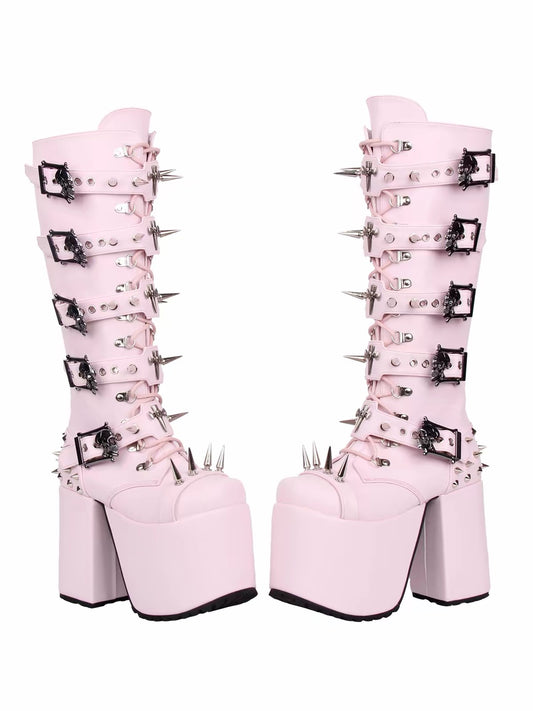 Pink knee-high platform boots with spikes, buckles and metal hardware