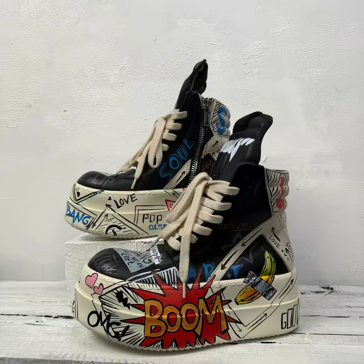 Black pop-art platform high-top shoes angled view