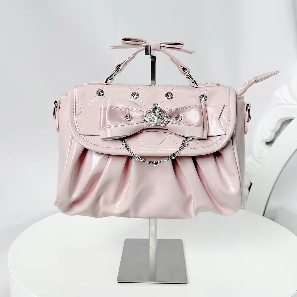 Pink bow rhinestone handbag with pleated body and crown detail