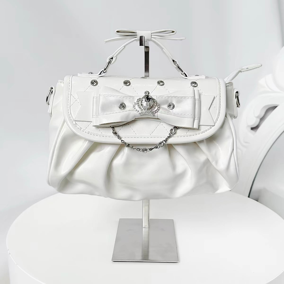 White bow rhinestone handbag with pleated body and crown detail