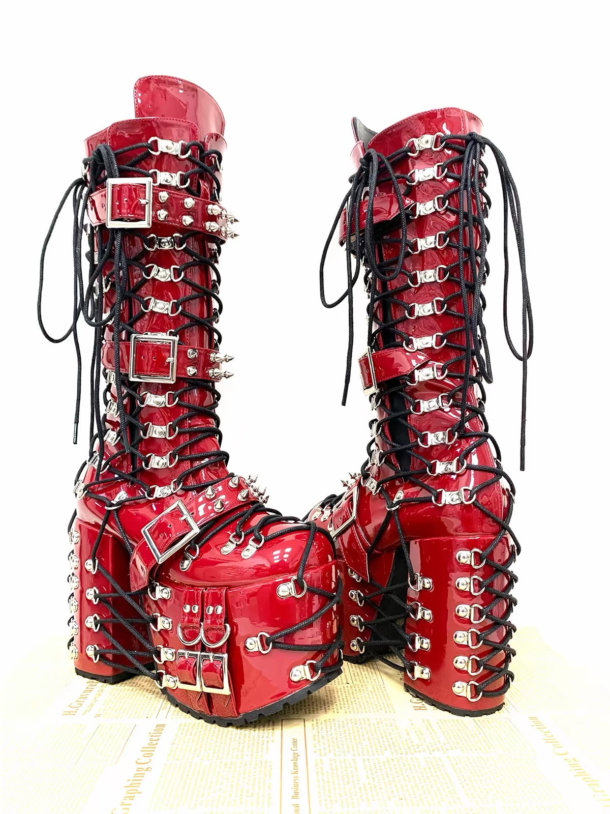 Red patent platform boots with black lacing and silver hardware