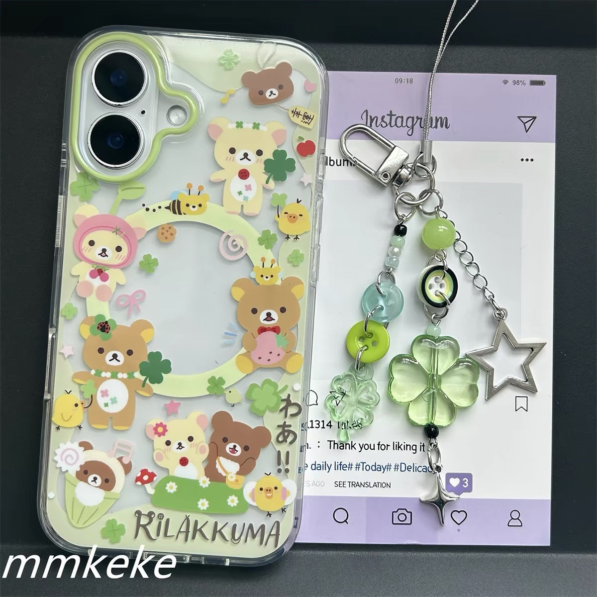 Rilakkuma clover phone case with green beaded charm beside the case
